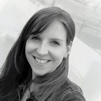 NEW Laura Newbold Breen ACID Black and white image of person (Laura Newbold Breen, CEO ACID) smiling at camera